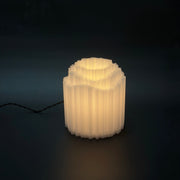 MINERA Clear lit against a dark background, its faceted translucent body glowing warm from within